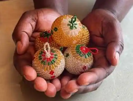Hands holding crafted beadwork items. ECD mothers' income generation initiative. Project Hope. KZN