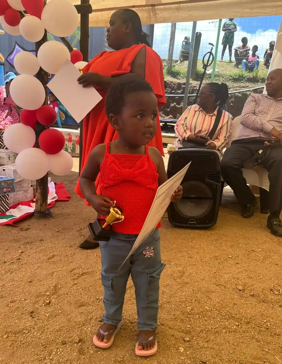 A little girl holding a certificate. Esihle, Best Student Award 2-3 Year Group. Project Hope ECD, KZN, SA.
