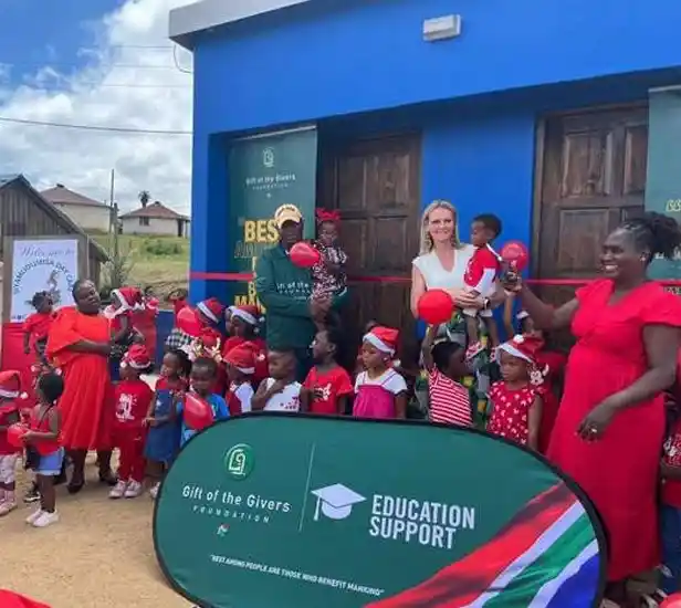 Children and Women standing in front of the new creche toilets. Sponsored by Gift of the Givers. Project Hope ECD. Ribbon cutting ceremony.