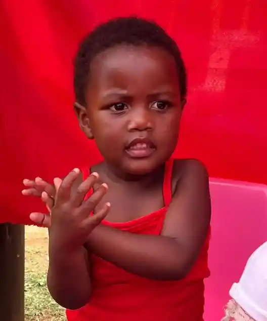 Little girl clapping. Esihle leads song at Project Hope ECD creche. South Africa