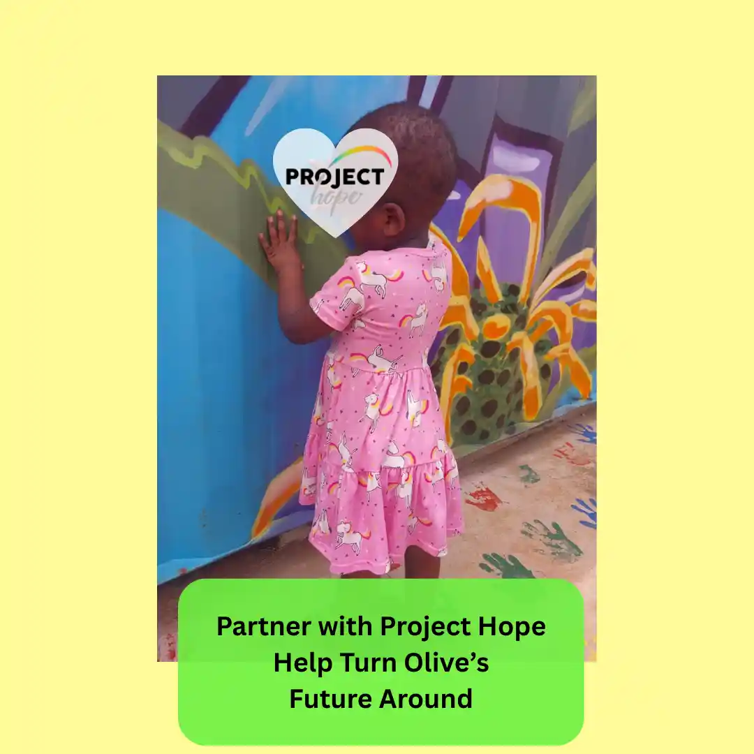 A little girl wearing a dress with unicorns on and facing a wall. Little Olive joins our ECD Nutrition Project Hope, KZN. Looking for CSI funding to give vulnerable children a positive future.