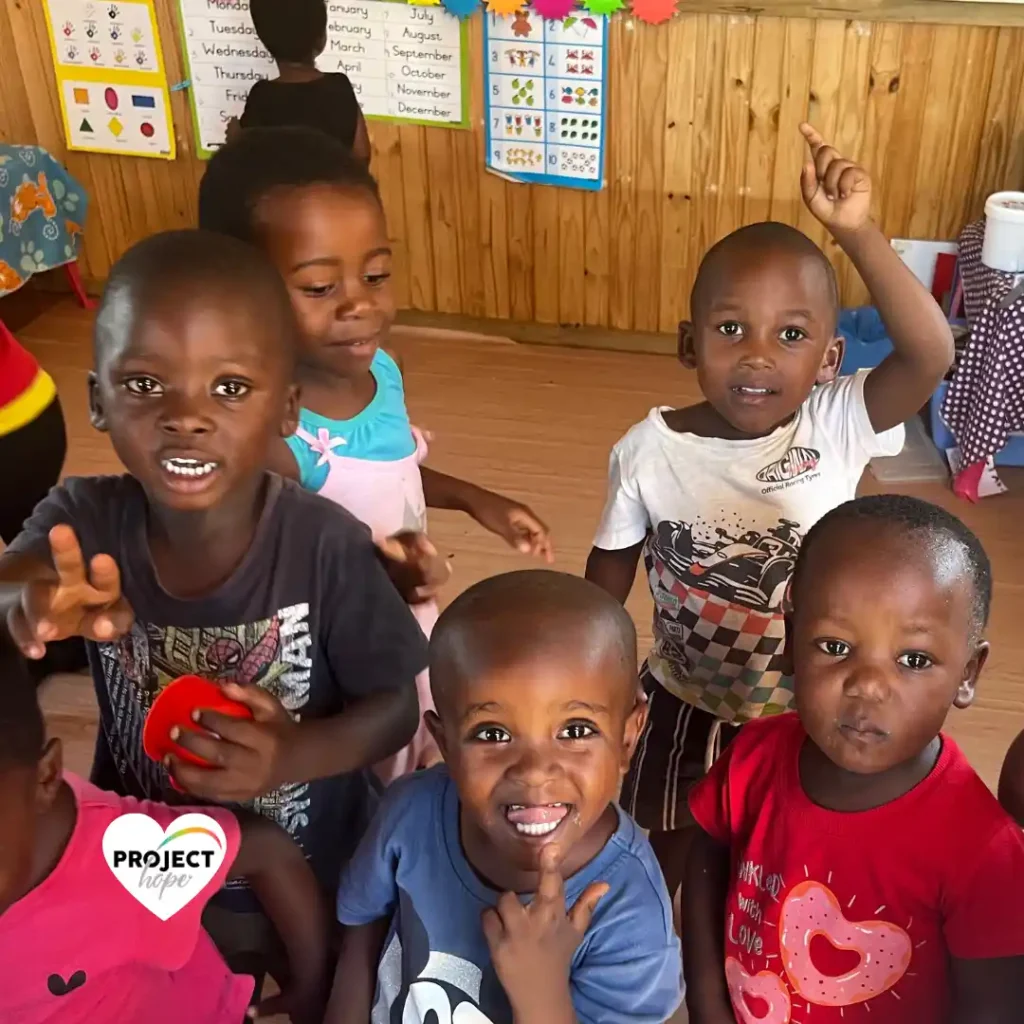 Bright, smiling faces of toddlers at preschool. Donate to child nutrition: Project Hope.
