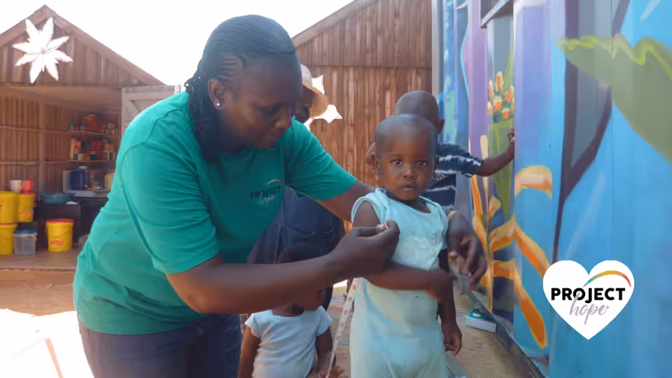 ePaP-prevents-stunting-MUAC-measure Children shoes in the preschool playground. Happy feet: Project Hope, SA.