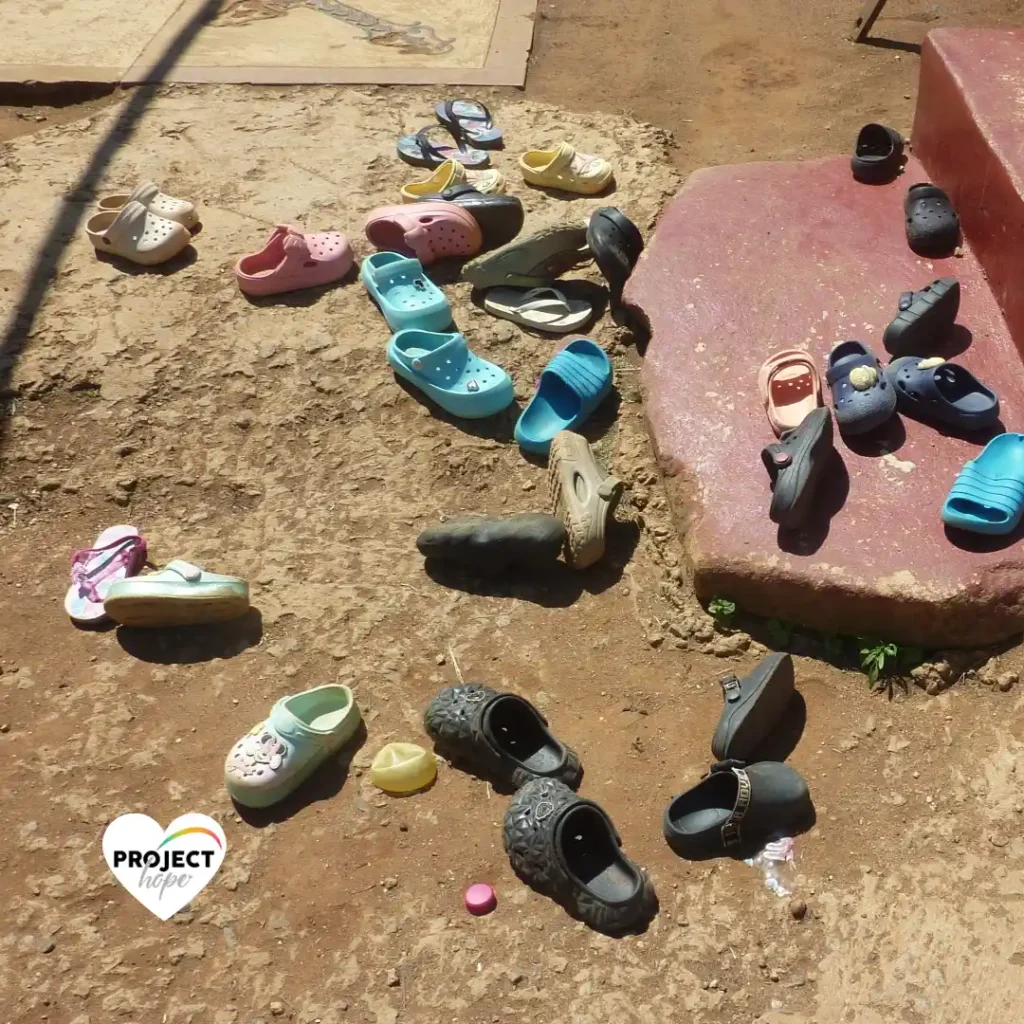 Children shoes in the preschool playground. Happy feet: Project Hope, SA.