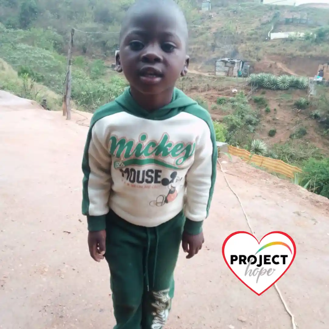 Sanele-Project-Hope-Preschool-Student Sanele stands confidently outdoors in a green and cream tracksuit on his way to his Project Hope partner preschool centre.